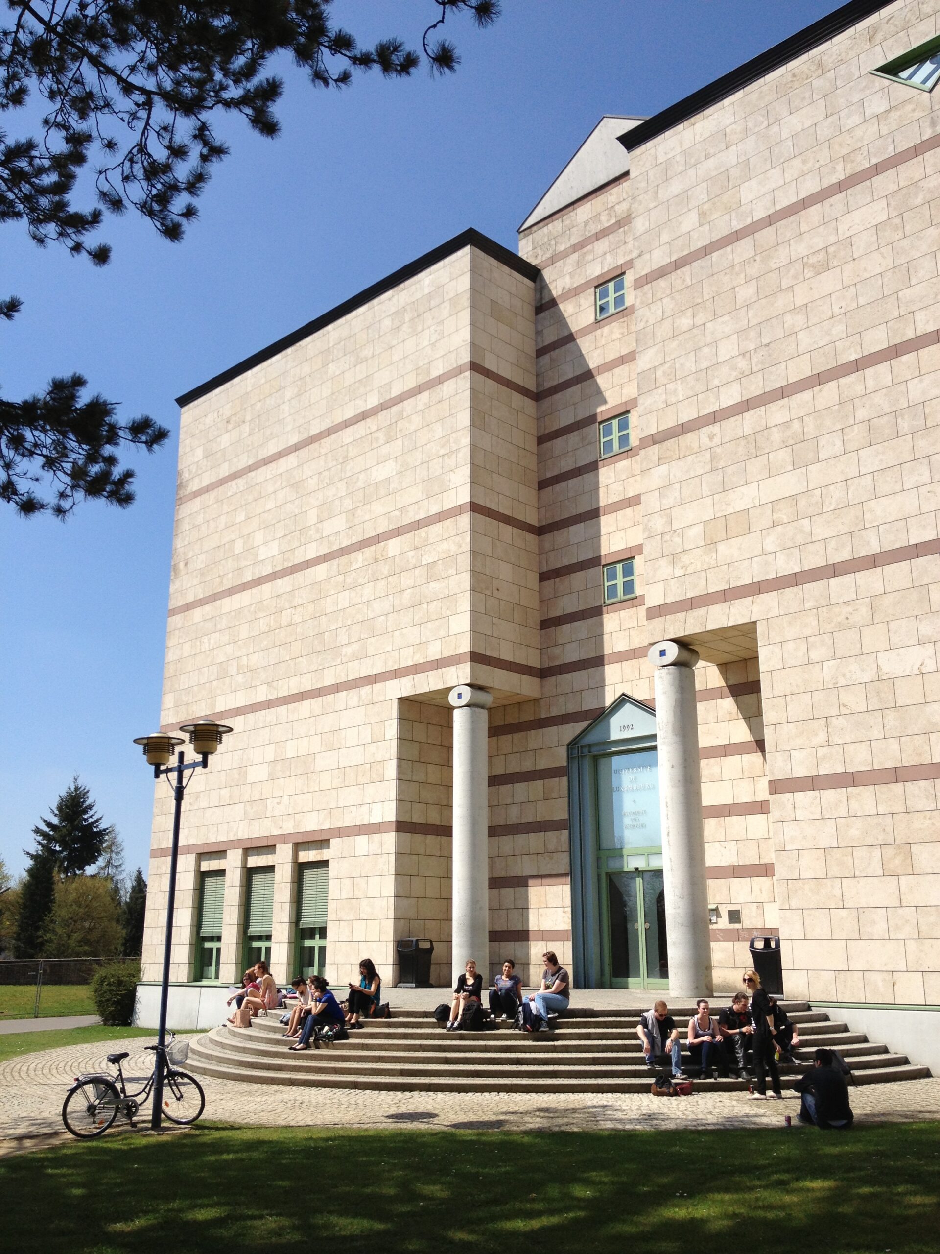 a building with students sitting on its steps