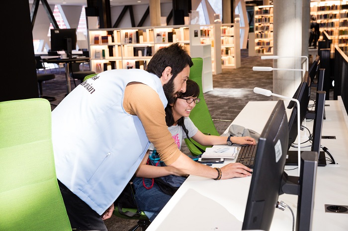 Ask a librarian. Librarian helping a student.