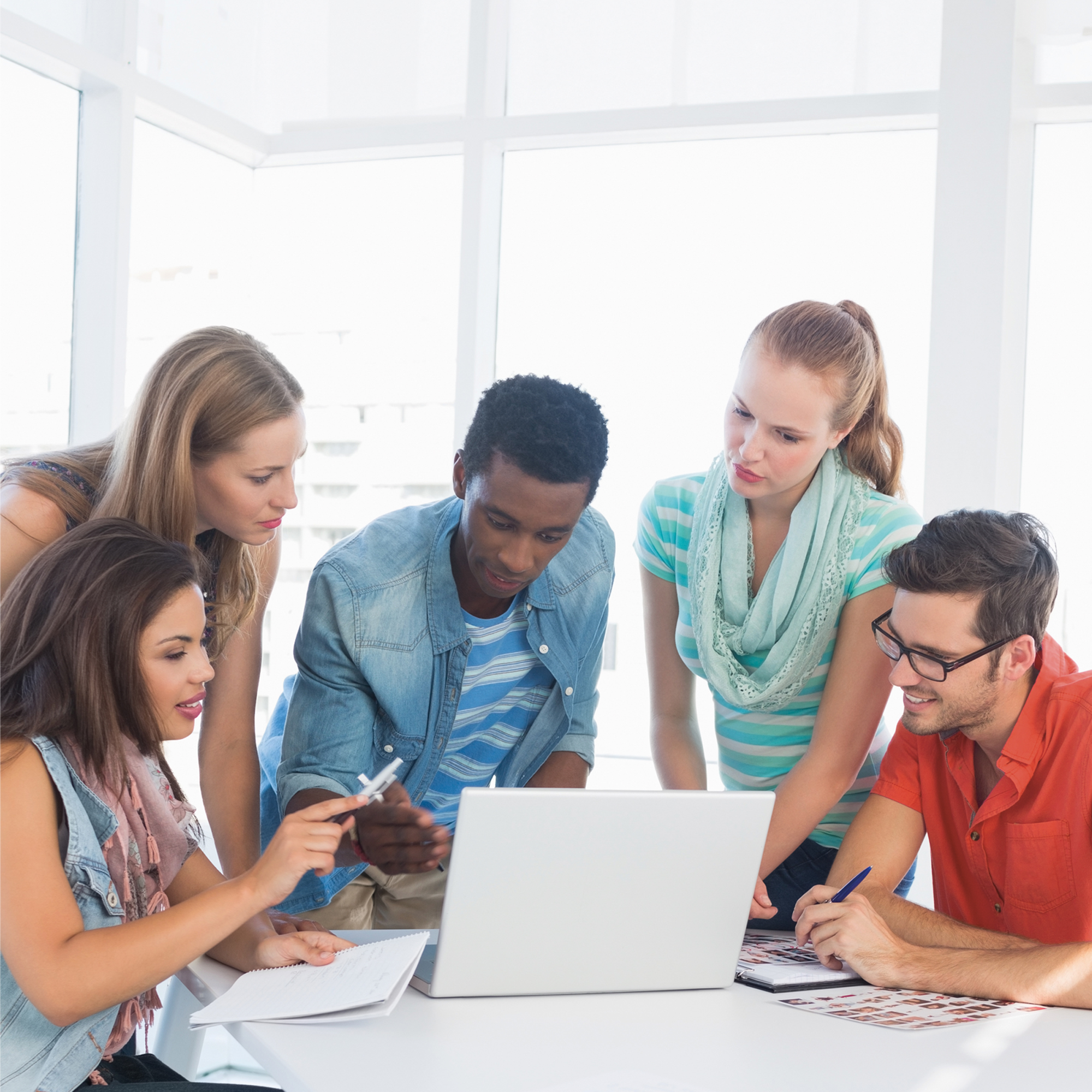 PhD students discussing around a computer