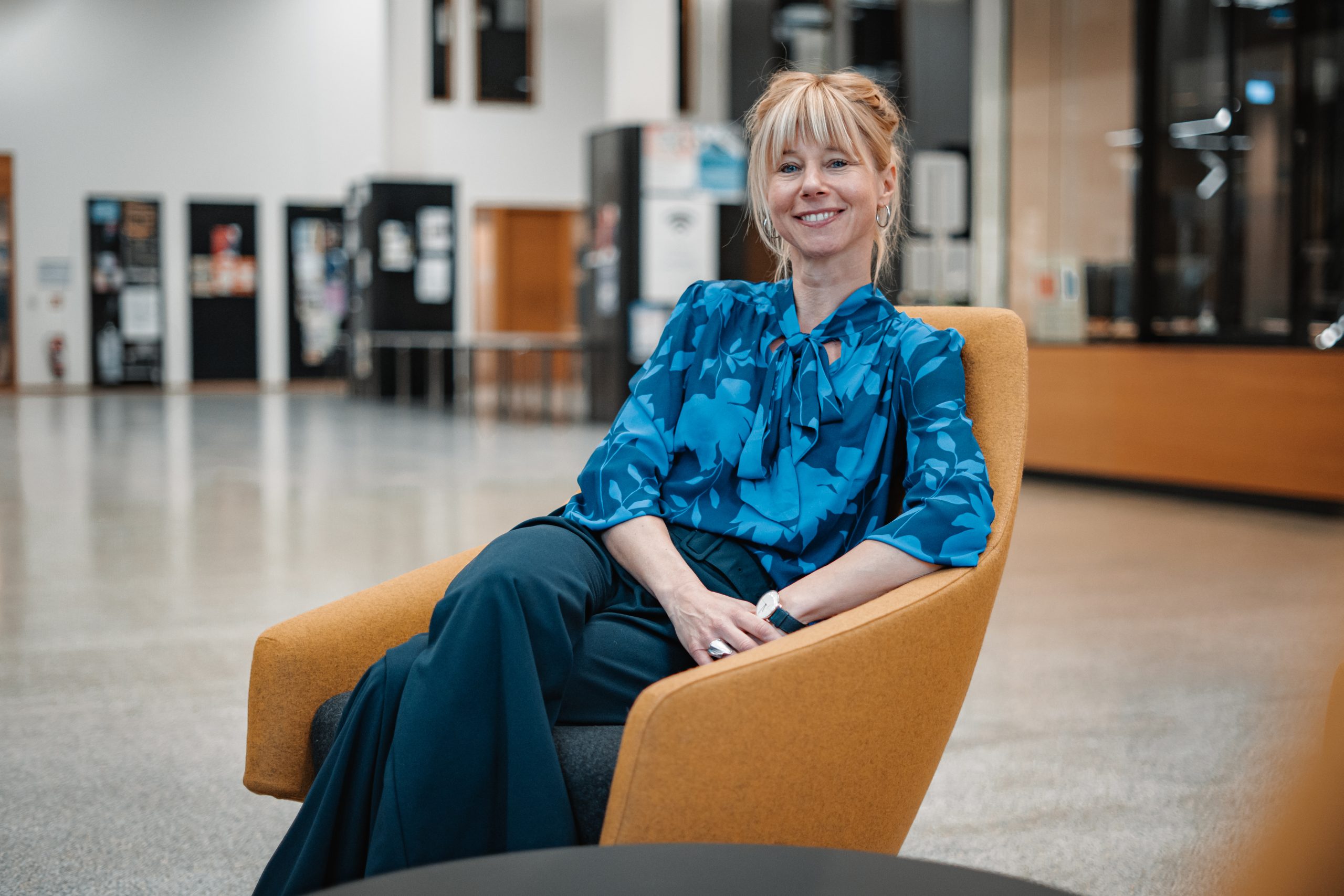 Janne Fengler sitting on a yellow chair