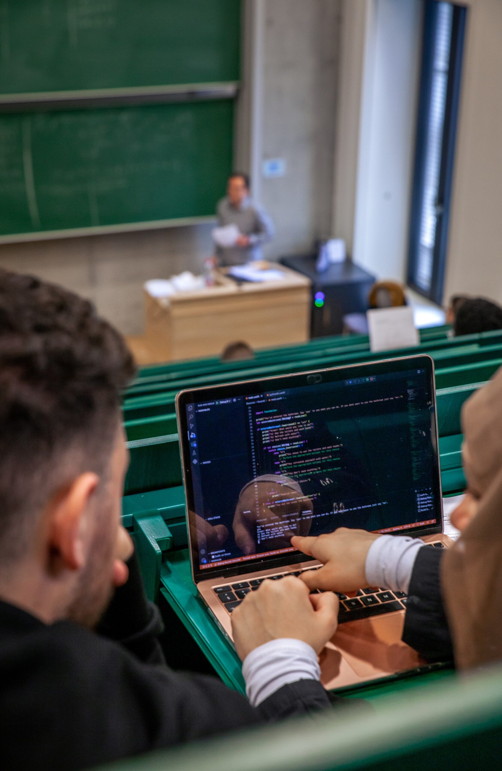 IT students on a laptop in a classroom