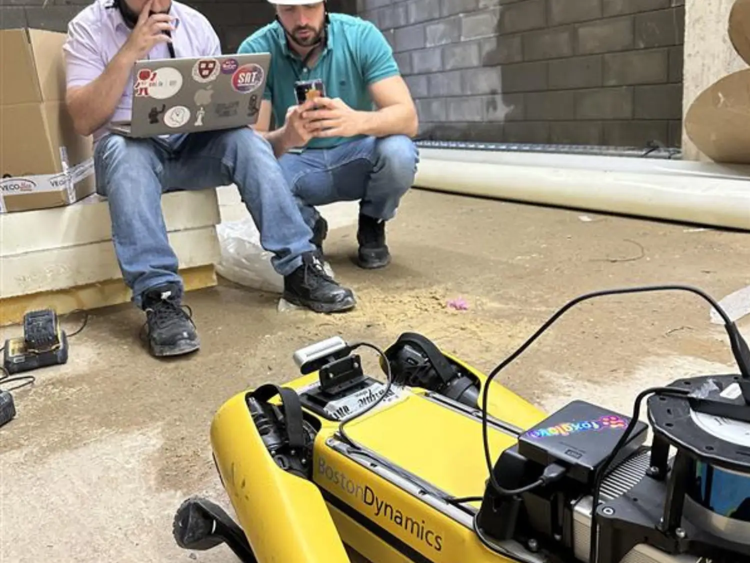 Researcher testing a robot at a construction site. 